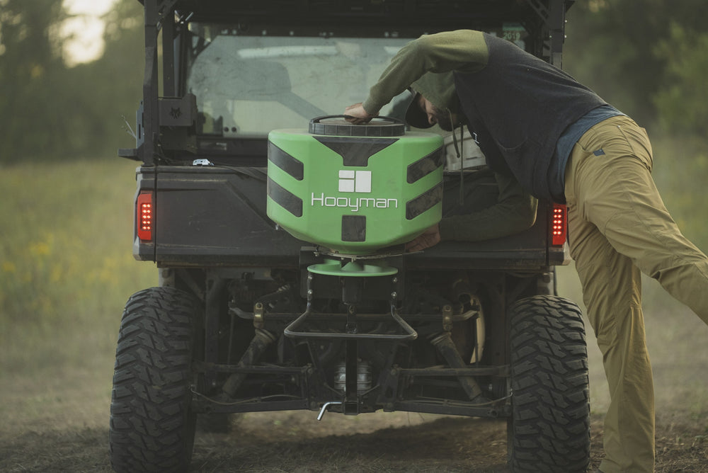 Hooyman 125 lb vehicle spreader mounted on an ATV