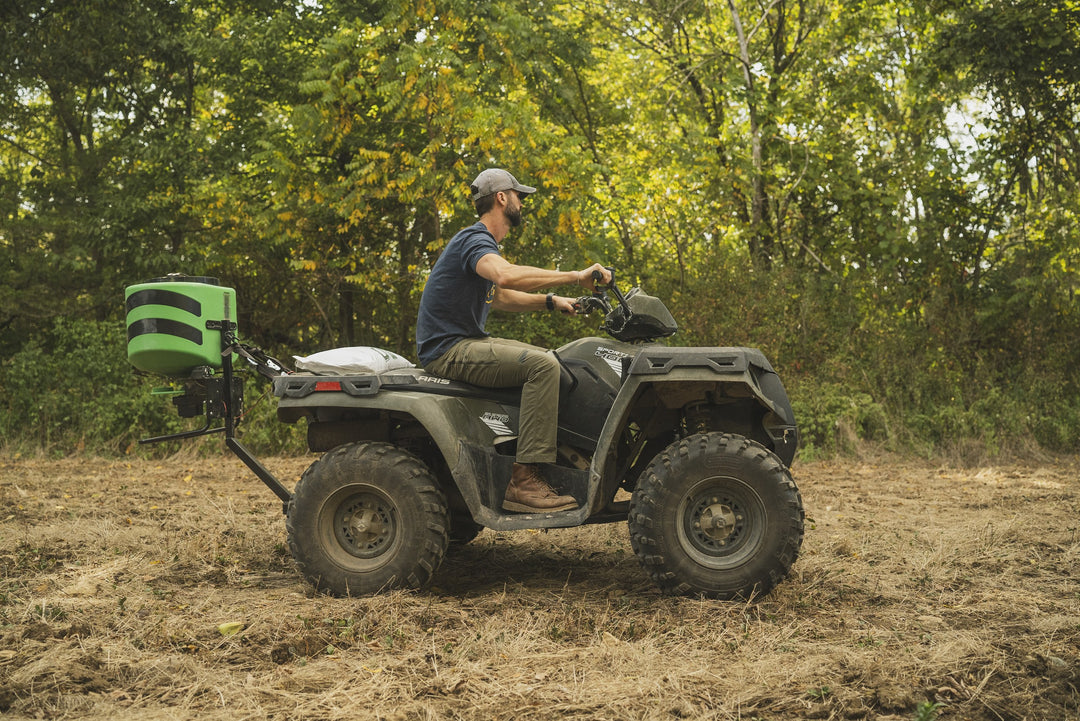 Hooyman 125 lb ATV spreader in use on a food plot