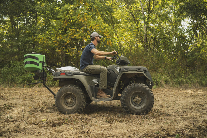 Hooyman 125 lb ATV spreader in use on a food plot