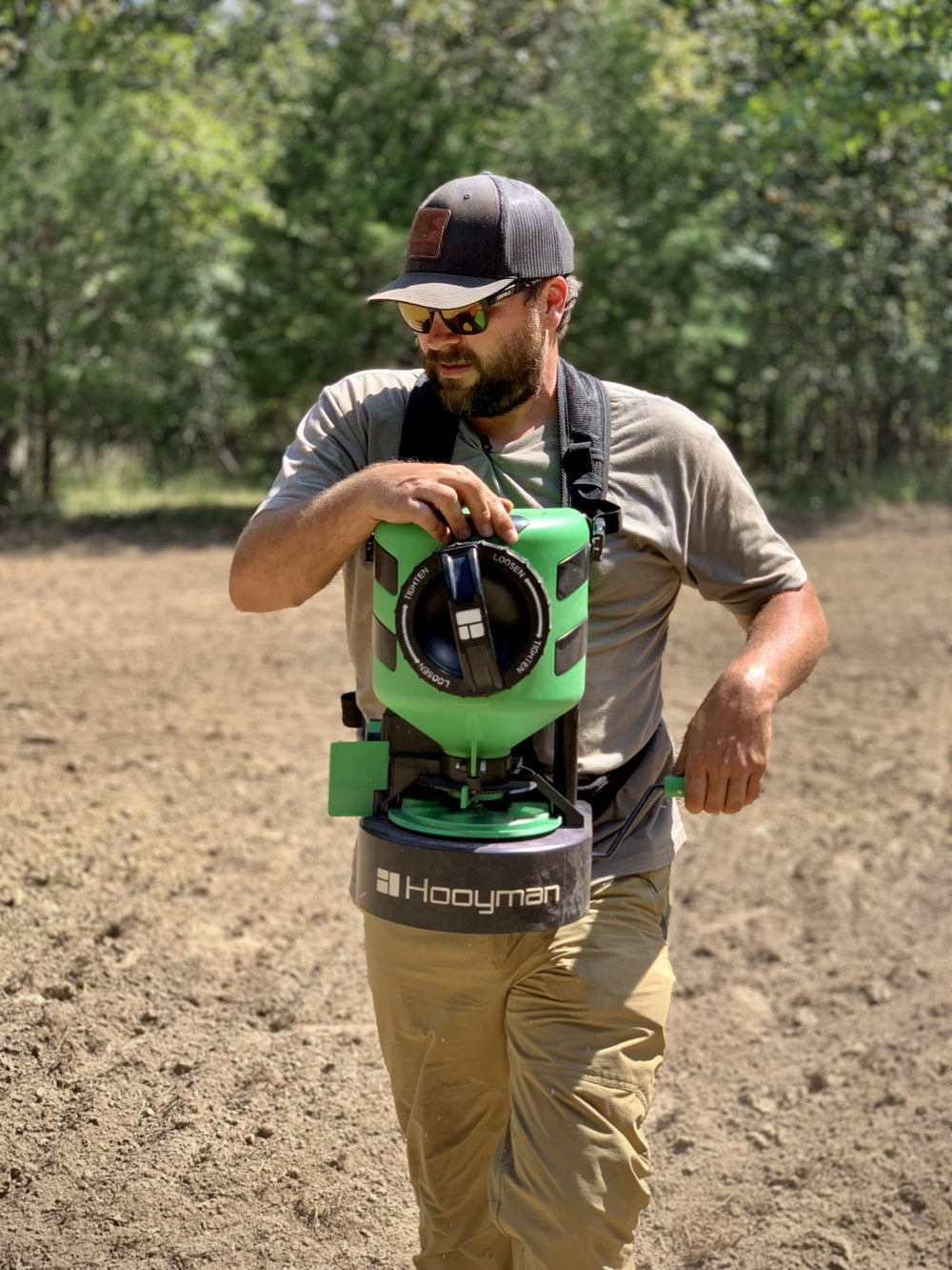 Hunter using the Hooyman manual chest spreader on a food plot