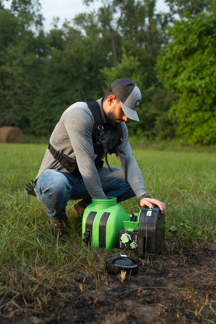 Hooyman 24V chest spreader in use on a deer food plot